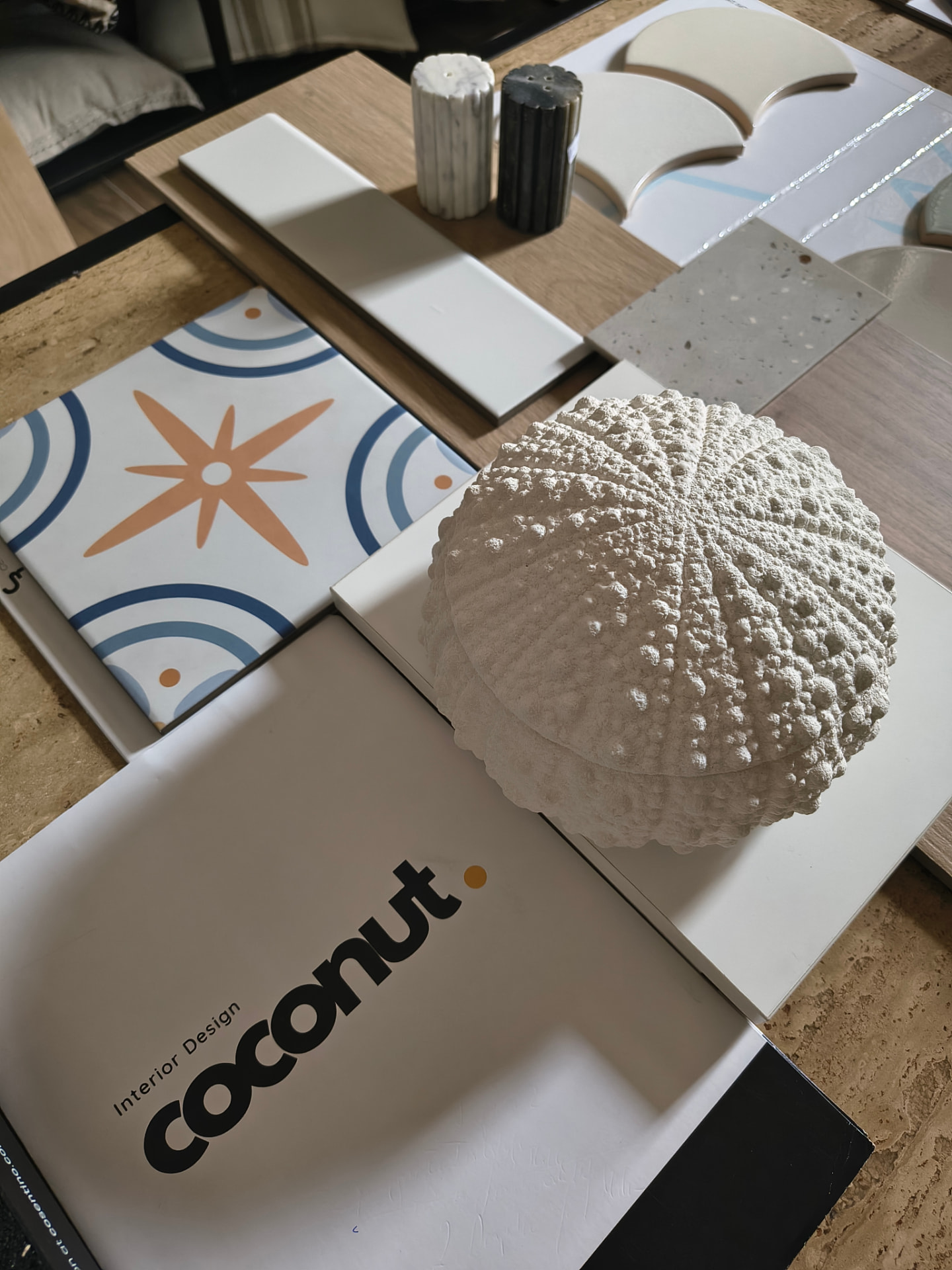 Wood, natural fabric and stone samples laid out on a light surface