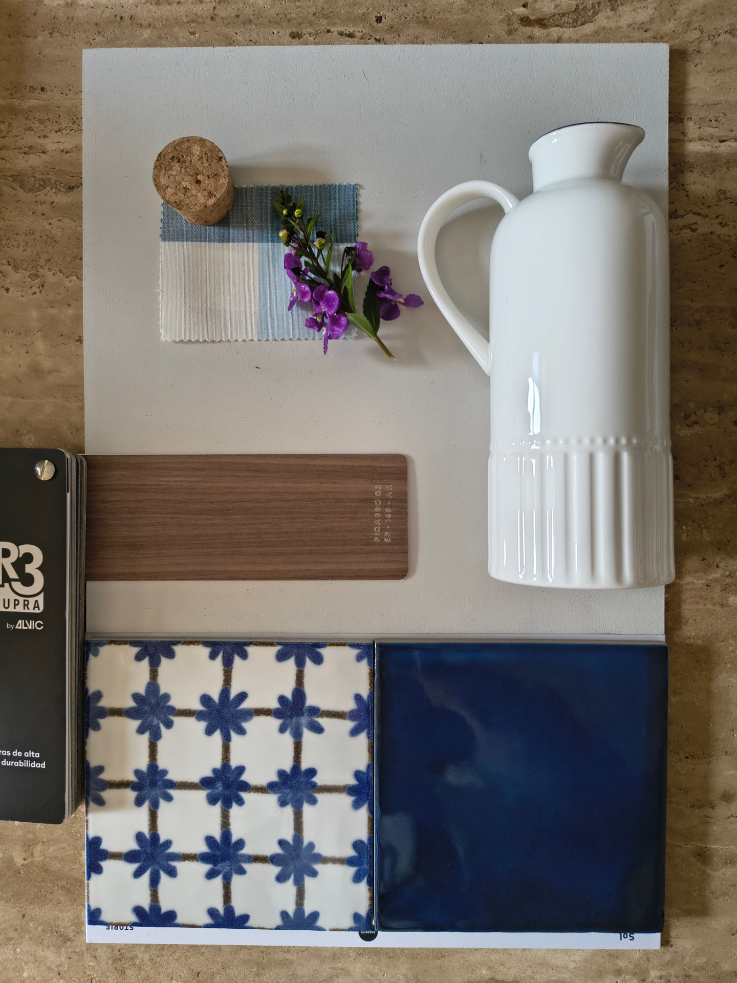 Moodboard with fabric, paint and material samples in blue and neutral tones